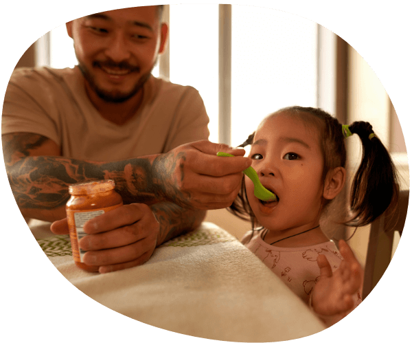 Father feeding daughter